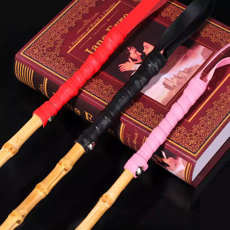 Close-up of leather handles on three bamboo segment discipline canes