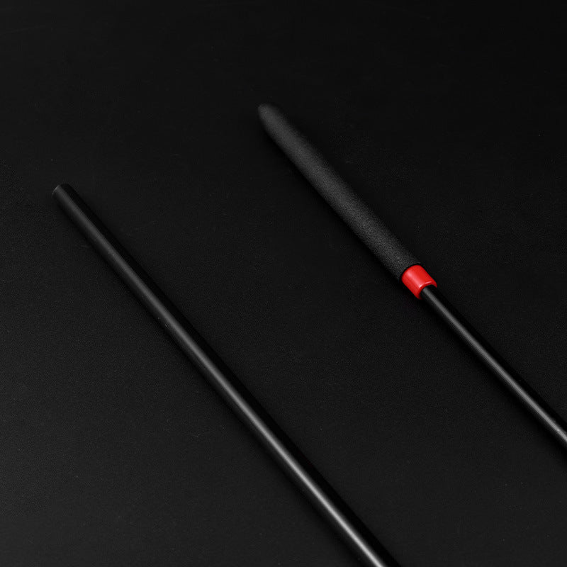 Close-up of tip on black acrylic BDSM discipline cane