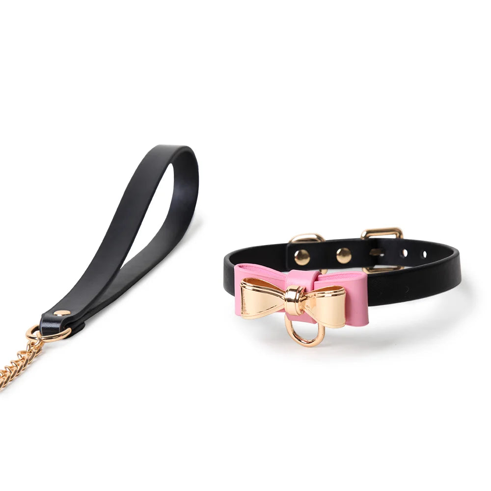 Black strap collar with pink bow and gold hardware leash