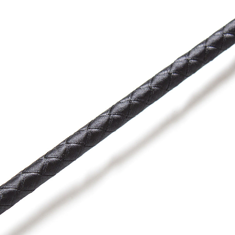 Close-up of shaft texture on black butterfly strap riding crop