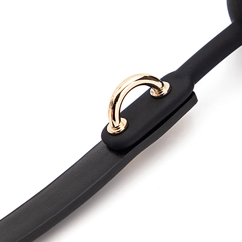 Latex ball and strap connection detail with gold-tone ring