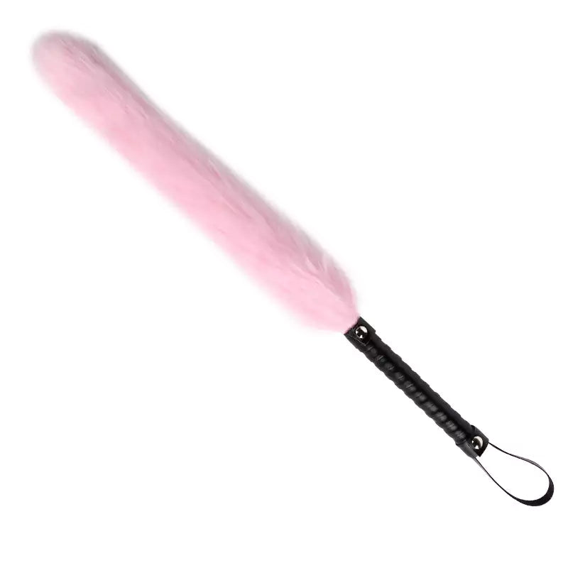 Angled display of pink fox tail flogger