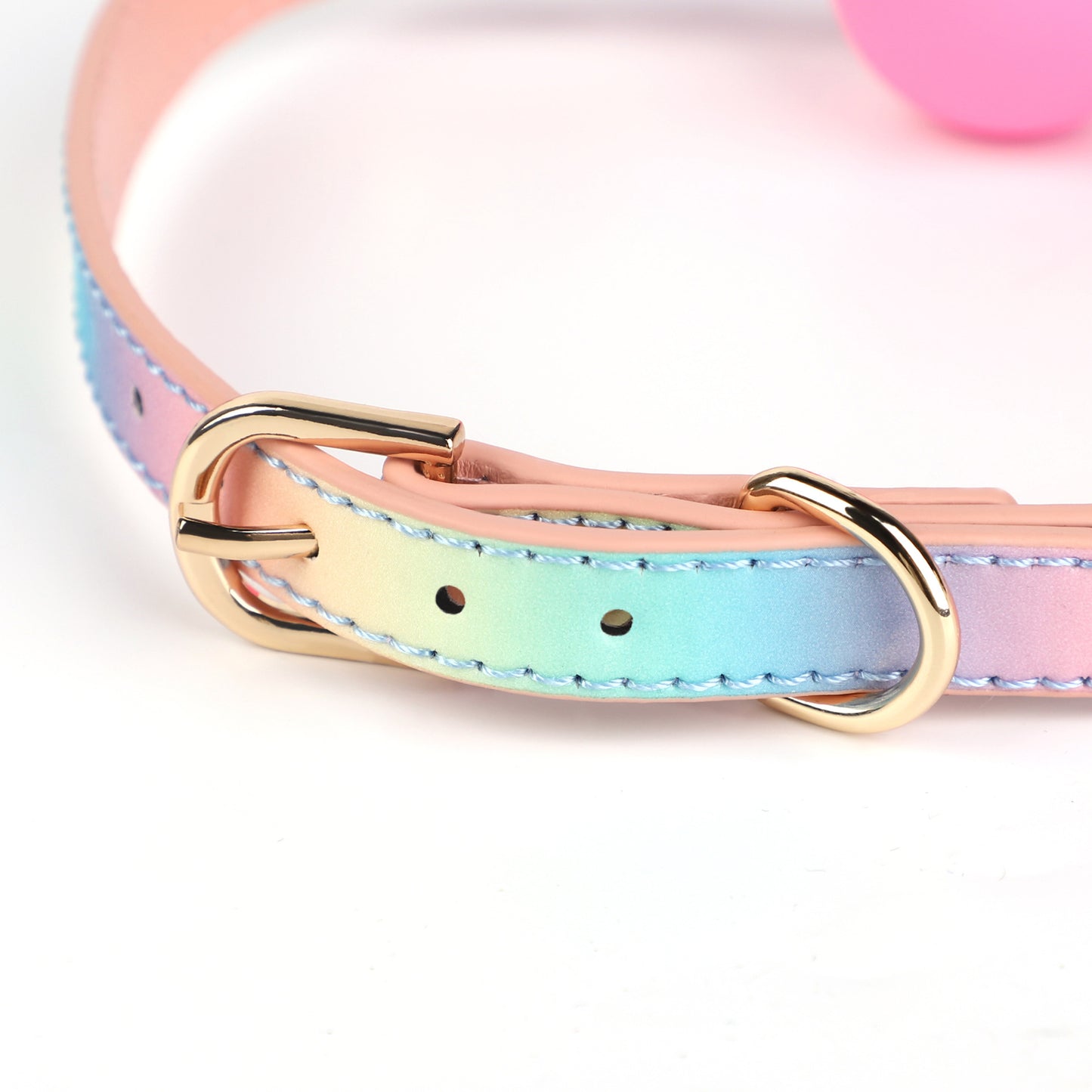 Close detail of iridescent strap and studded hardware on ball gag