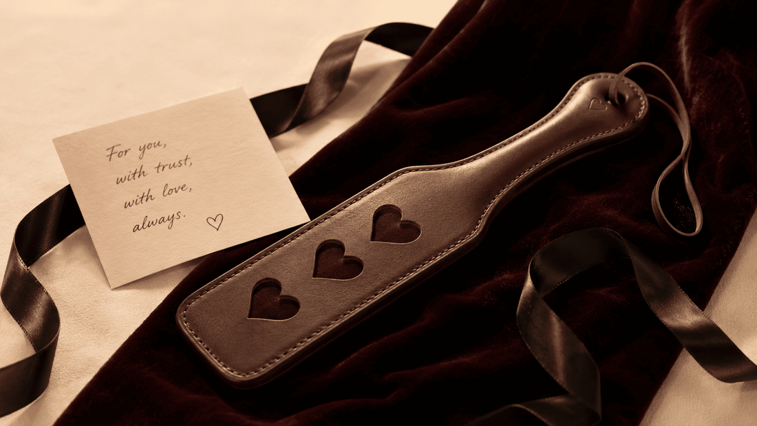 carefully chosen leather paddle beside handwritten card on dark velvet gift presentation