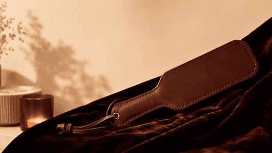 compact leather paddle on dark surface suited for solo impact play self delivery