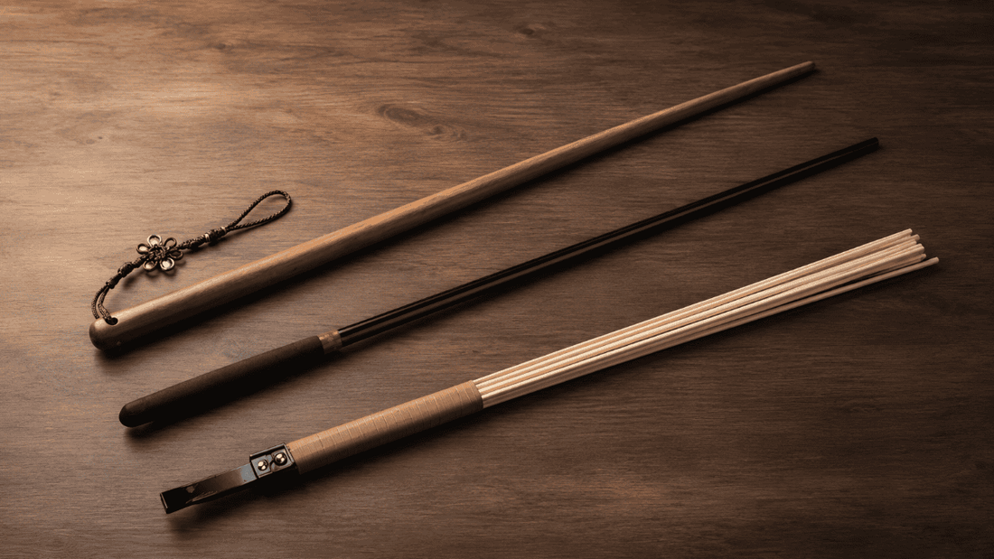 rattan acrylic and hardwood canes arranged on a warm wooden surface