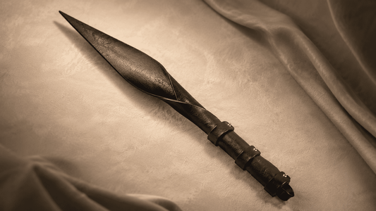 dragon tail leather implement on dark surface showing tapered tip and distinctive design