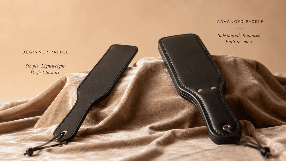 beginner leather paddle beside more advanced implement showing progression on dark surface