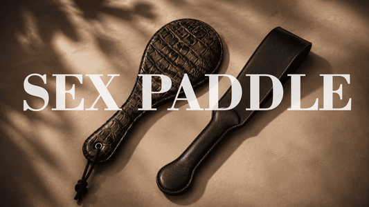 genuine leather paddle and black PU leather paddle in moody studio lighting