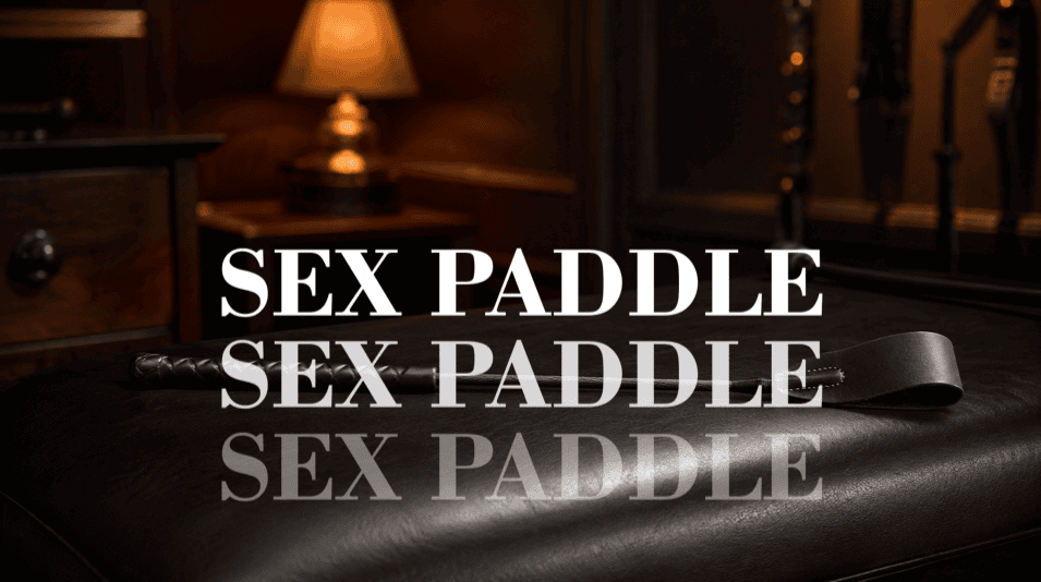 black leather riding crop resting in a warm moody spanking room