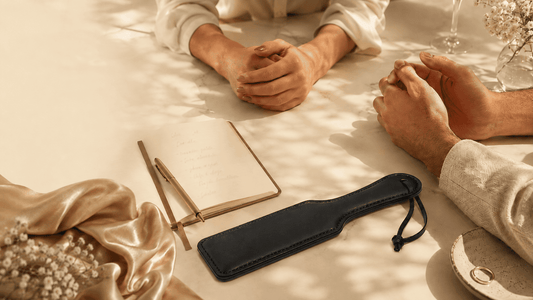 two partners in calm conversation beside leather paddle on dark surface showing communication shift 
