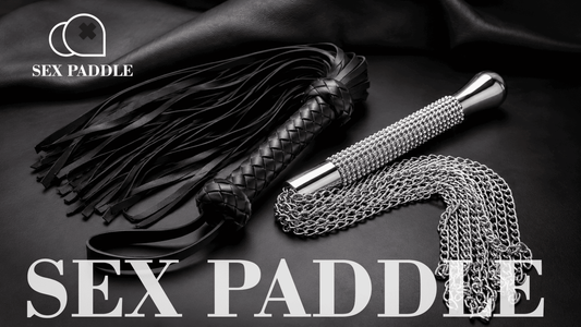 metal chain flogger and black leather flogger in moody studio lighting