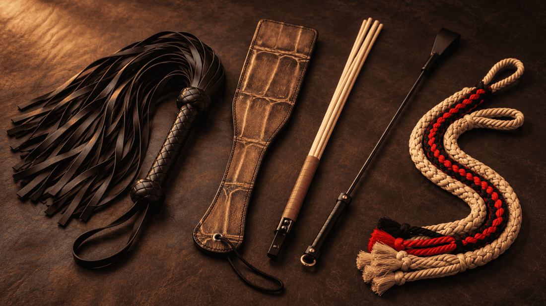 Paddle, flogger, three-rod cane, riding crop and braided whip arranged for comparison