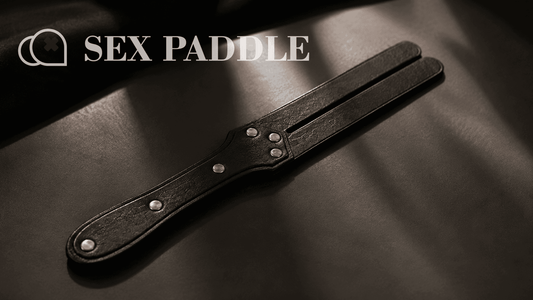 black leather split tip paddle in moody studio lighting