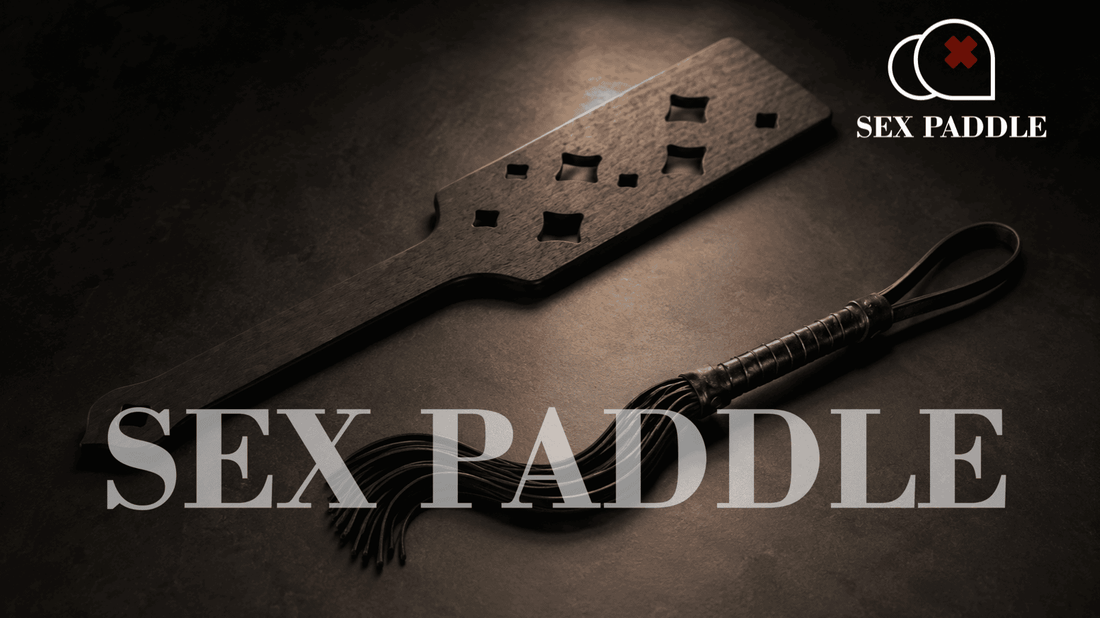 perforated wooden paddle and leather flogger in moody studio lighting