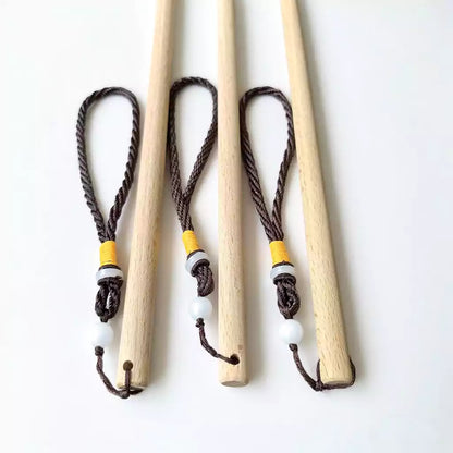 Close-up of beechwood round discipline rod handle end showing wood grain
