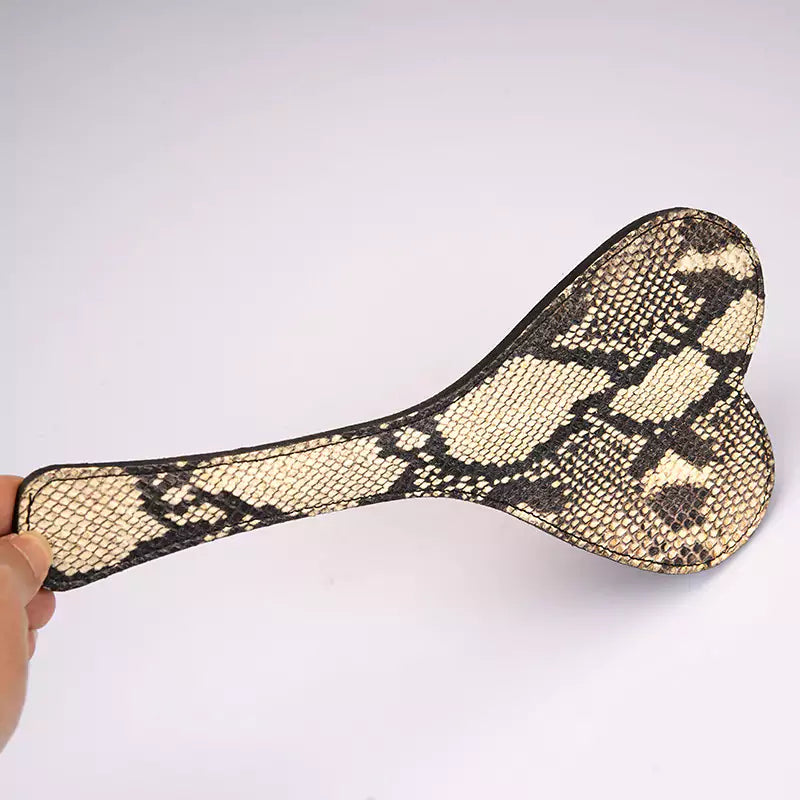 Close-up of the snake-pattern finish on the beige heart paddle