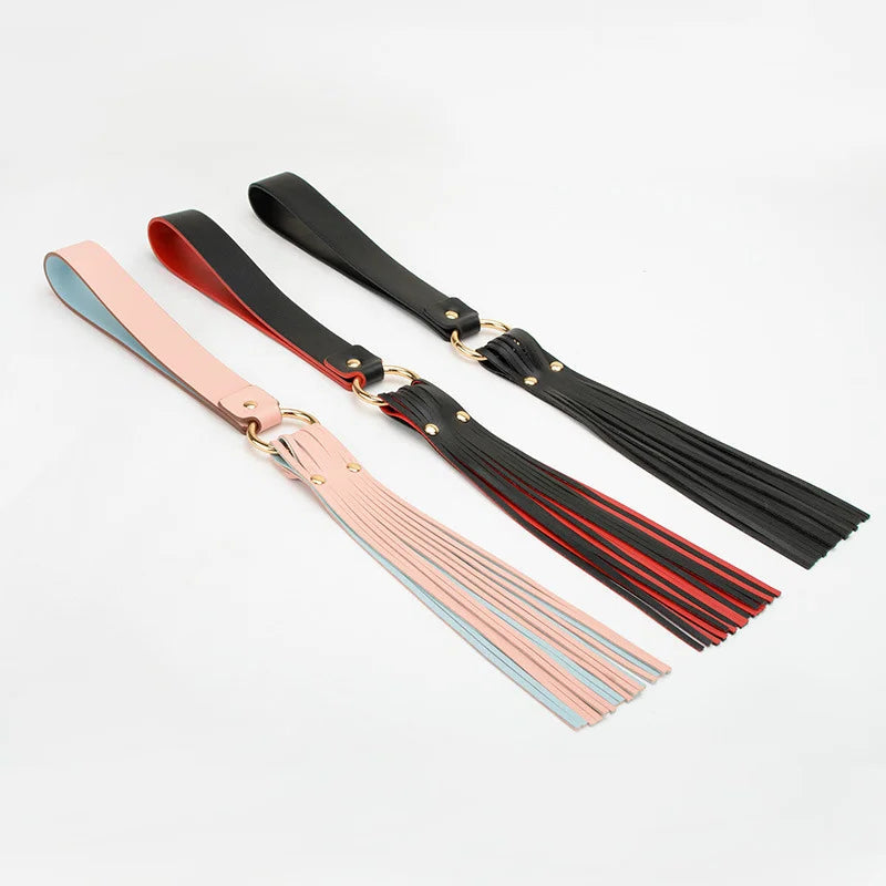 three color variations of belt-style flogger displayed together