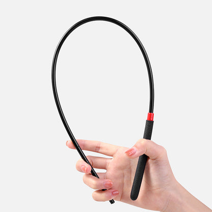 Black acrylic BDSM cane bent showing controlled flexibility