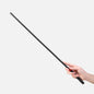 Black acrylic BDSM cane held in hand showing grip and control