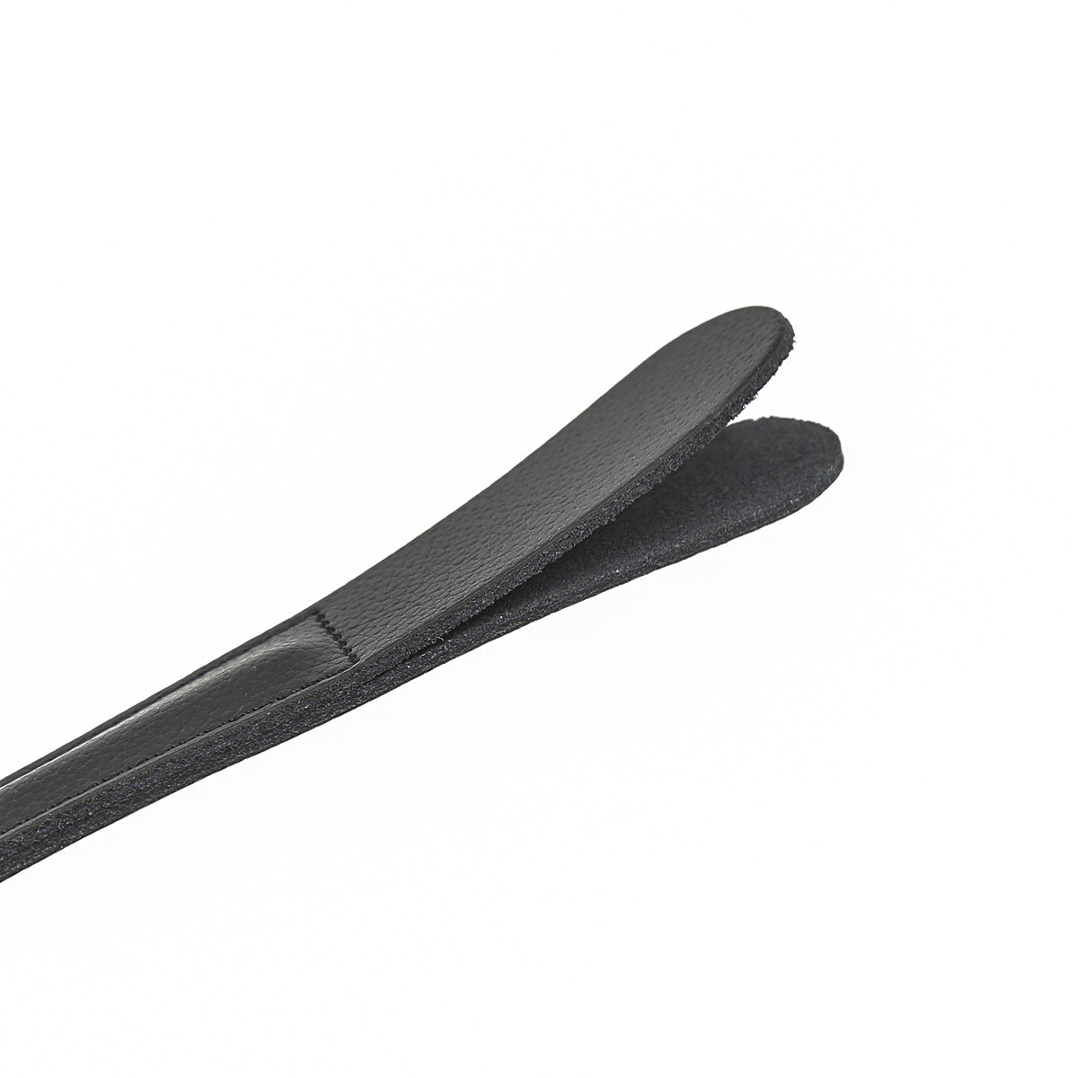 Close-up of dual-layer cowhide leather striking tip on black riding crop