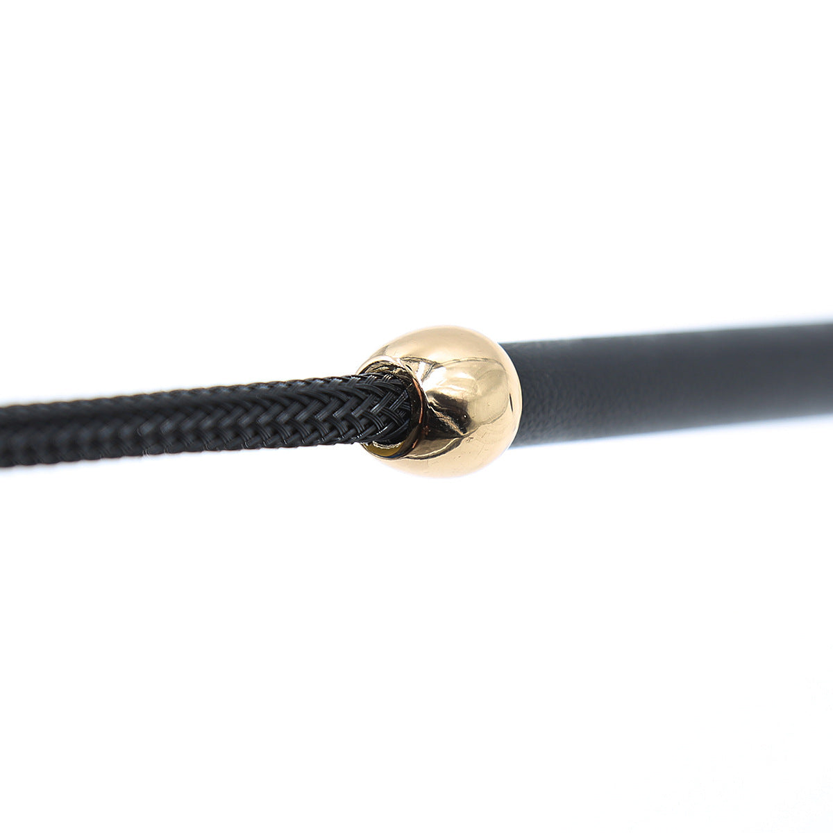 Close-up of shaft connection and gold hardware on black cowhide riding crop