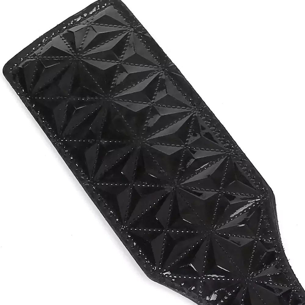 Close-up of black diamond-embossed faux leather paddle surface