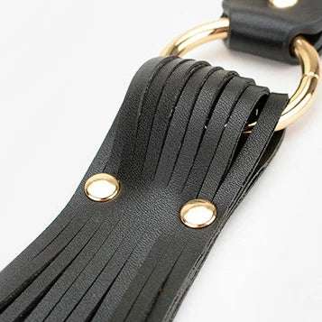 black metal hardware detail on belt-style flogger