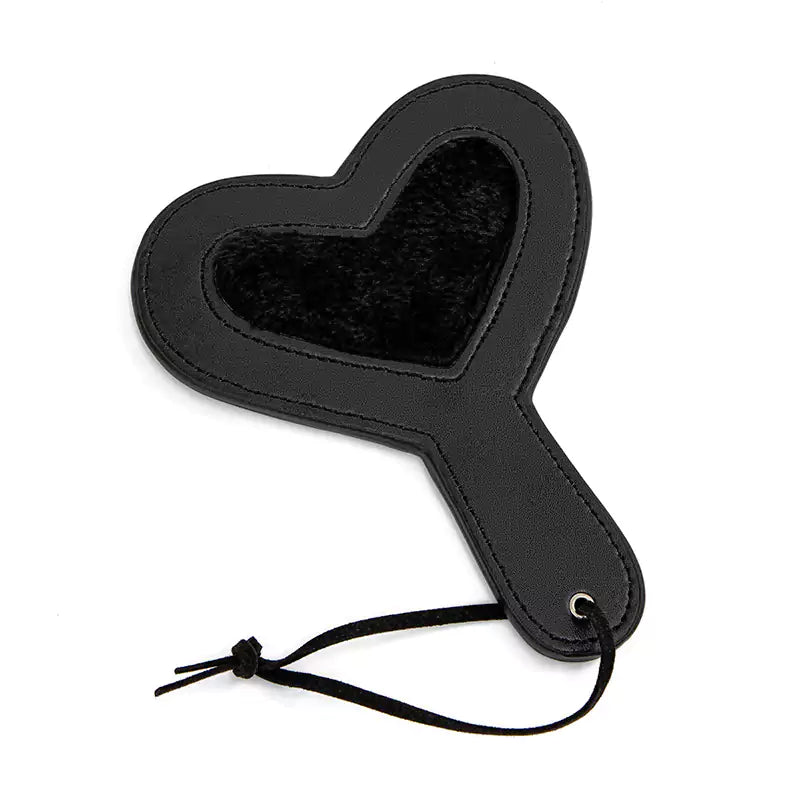 Black plush heart paddle on white background