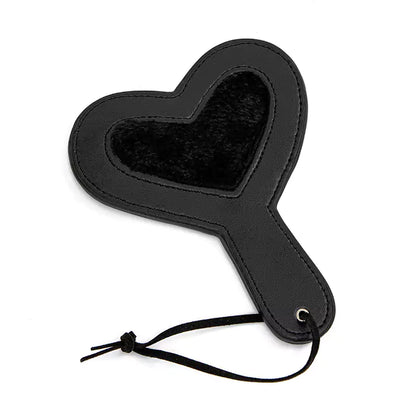 Black plush heart paddle on white background