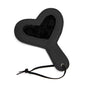 Black plush heart paddle on white background