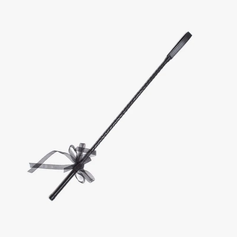 Black lace riding crop full view showing braided shaft and lace ribbon handle