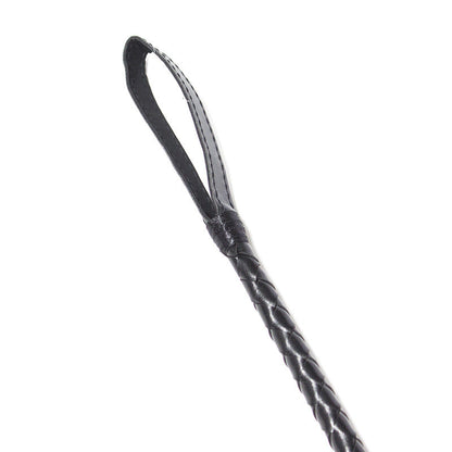 Close-up of faux leather striking tip on black lace riding crop