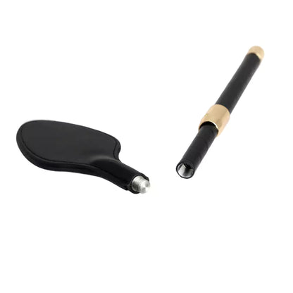 Detachable head mechanism detail on black leather riding crop paddle