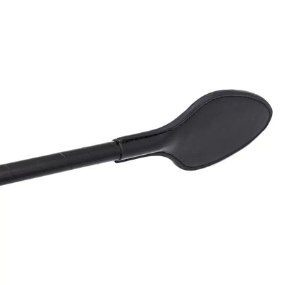 Close-up of sculpted PU leather head on black riding crop paddle
