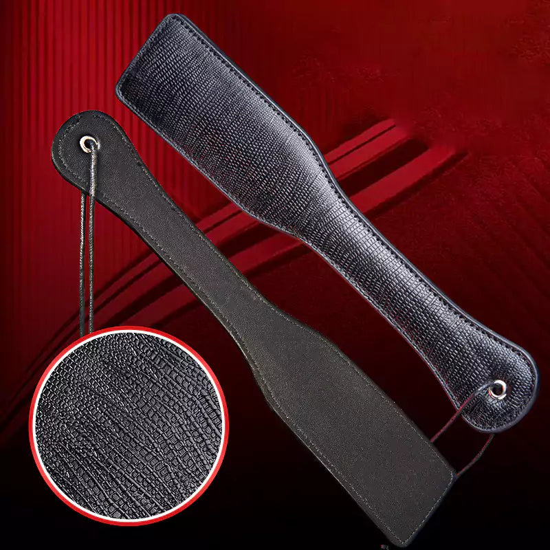 Close-up of vertical and horizontal grain texture on leather spanking paddle