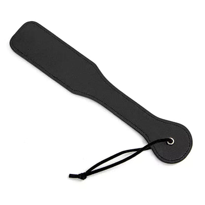 Back view of black smiley leather spanking paddle showing smooth surface