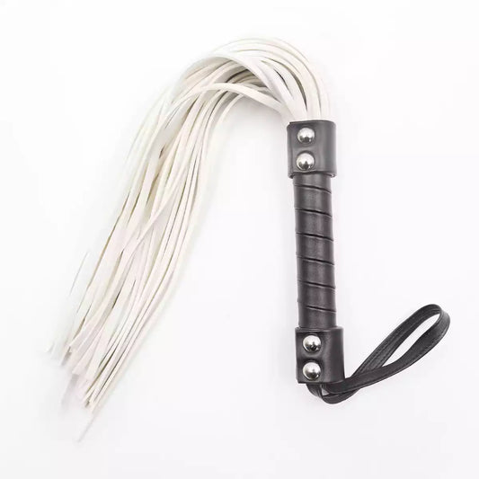 Black and white suede flogger full view under neutral studio lighting