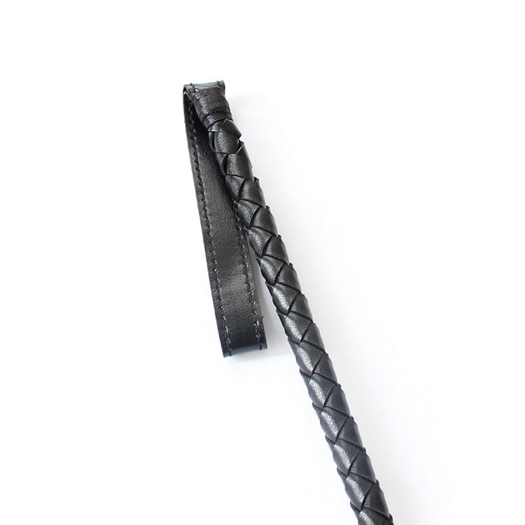 Close-up of hand-braided faux leather shaft texture on riding crop