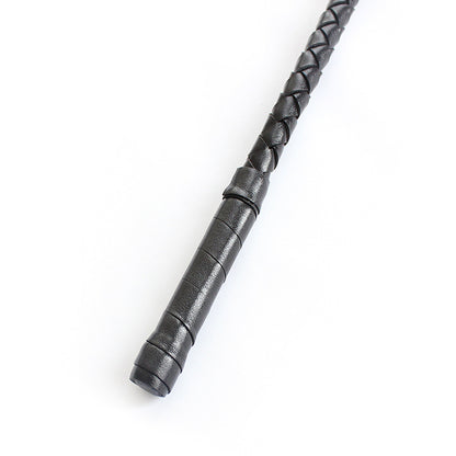Close-up of braided leather striking tip on BDSM riding crop