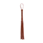 angled view of brown leather flogger emphasizing soft draping motion