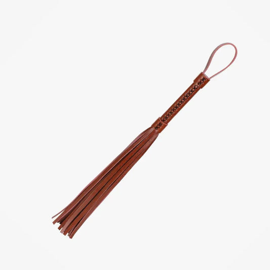 deep brown handmade leather flogger displaying refined artisanal construction