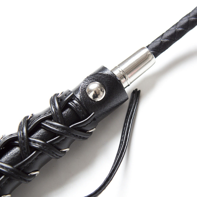 Close-up of butterfly strap leather decoration on riding crop handle