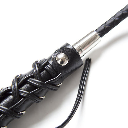 Close-up of butterfly strap leather decoration on riding crop handle