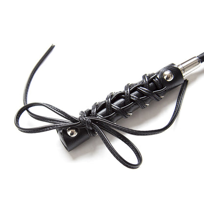 Second close-up of butterfly strap handle detail on BDSM riding crop