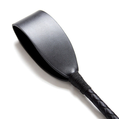 Close-up of faux leather striking tip on butterfly strap riding crop