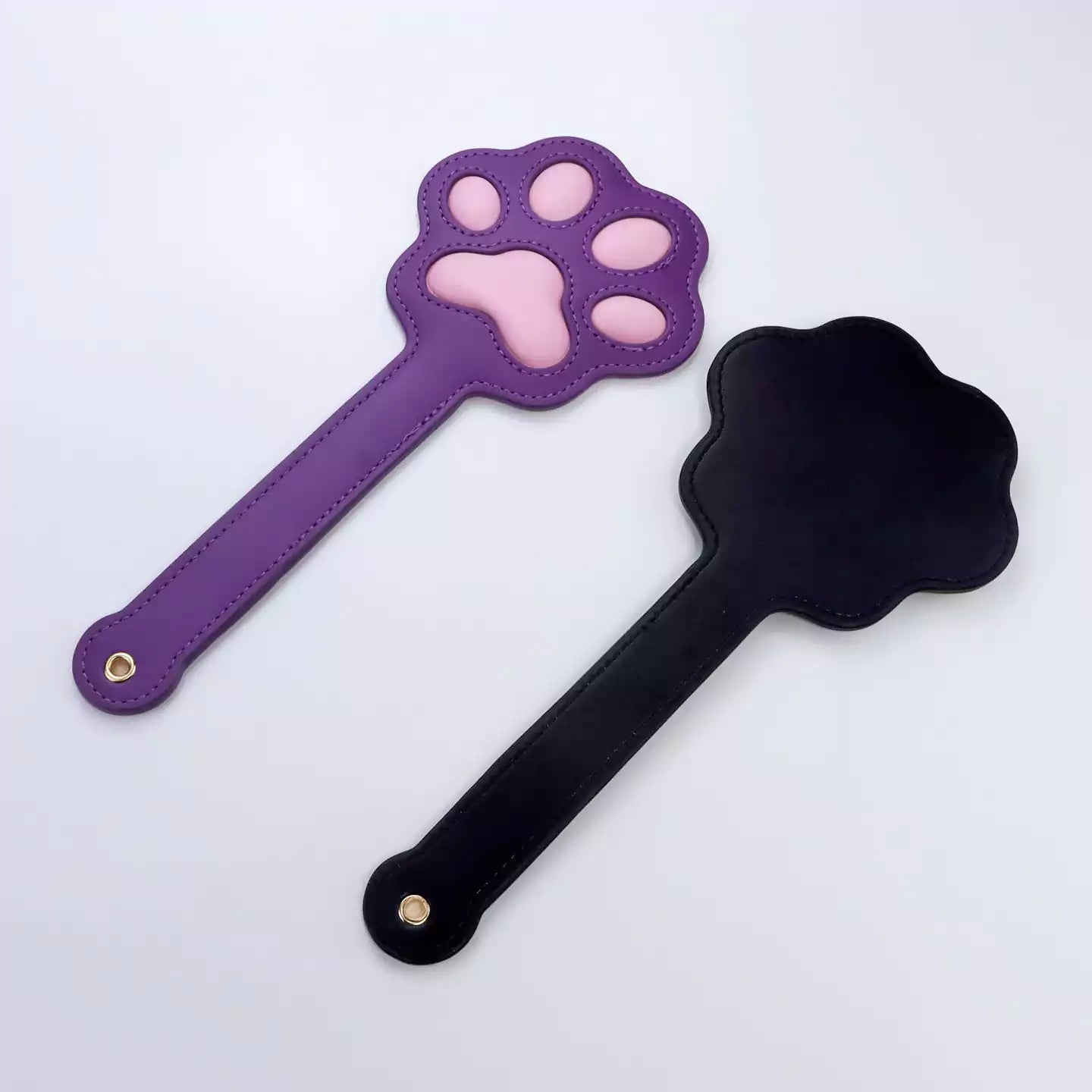 Front and back view of cat paw silicone spanking paddle