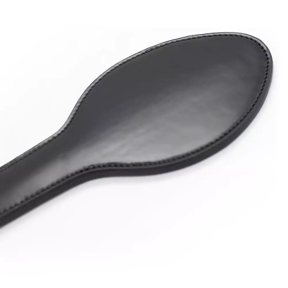 Close-up of faux leather strike surface on black paddle