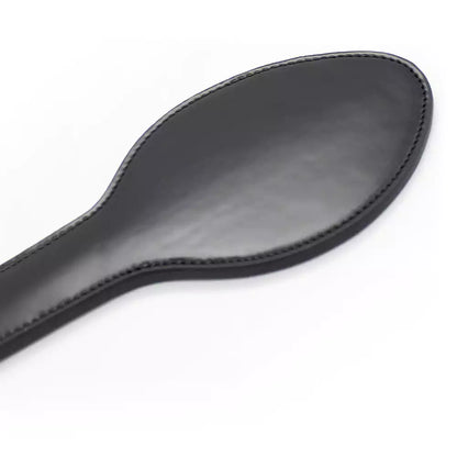 Close-up of faux leather strike surface on black paddle