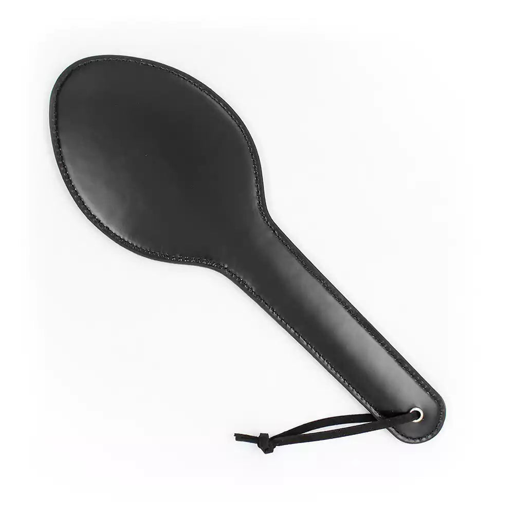 Black faux leather spanking paddle on white background